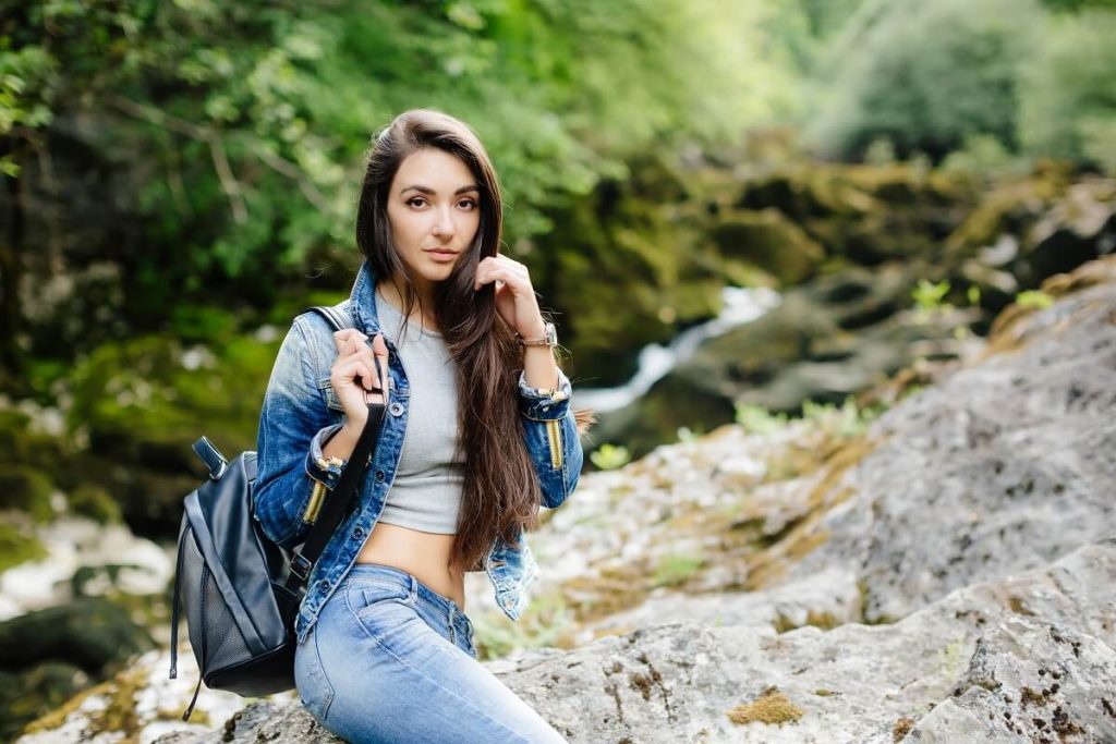 Attractive Women Travel with Back Pack in Mountain