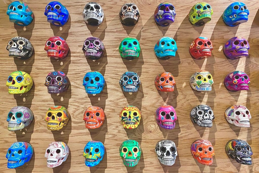 colorful flatlay background of painted mexican skulls